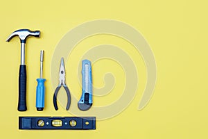 Toolbox set of tools. Home improvement concept on yellow background.