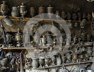 Toolmaker`s or metal craftsman`s workshop with copper container or vintage pots.