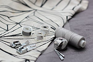 Tools and accessories for sewing on a background of linen fabric