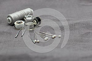 Tools and accessories for sewing on a background of linen fabric