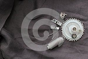 Tools and accessories for sewing on a background of linen fabric