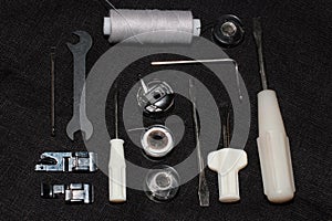 Tools and accessories for sewing on a background of linen fabric