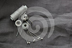 Tools and accessories for sewing on a background of linen fabric