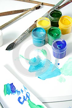 Tools of the artist: paints, brushes and a paper