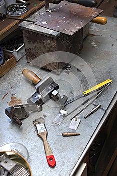 Tools, components and finished mold lie on a bench in the handcraft.