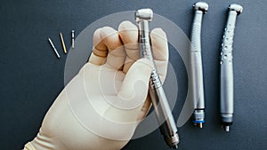 Tools dentist hand holding dental handpiece