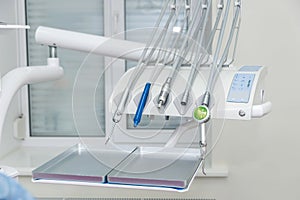 Tools in dentistry near chair close up