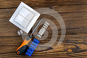 Tools of an electrician installer or Builder on a dark wooden table. The concept of making an estimate or list of construction