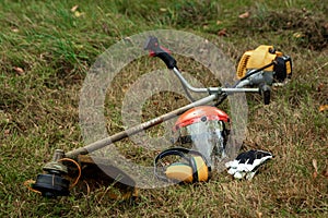 Tools and equipment for mowing grass, the lawn lies on the ground, a grass trimmer. Mowing lawns, roadsides, mowing grass photo