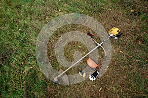 Tools and equipment for mowing grass, the lawn lies on the ground, a grass trimmer. Mowing lawns, roadsides, mowing grass photo