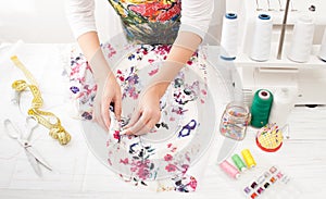 Sewing and cutting of clothes on a white table