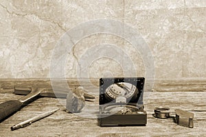 Tools geologist laid out on a wooden table on the background of a topographic map. Background. Toning