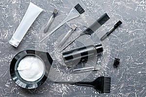 Tools for hair dye in barbershop on gray background top view