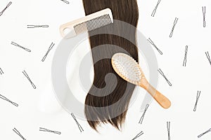 Tools for hairdresser with shampoo and hairs on white background. Flat lay, top view
