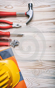 Tools, hardhat on wooden desk, top view