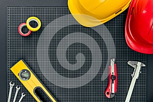 Tools and hardhats on graph paper