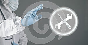 tools icon. wrench and screwdriver. the doctor clicks on the screen. tech support concept