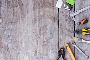 Tools kit on a wood background.