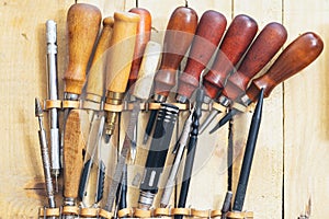 Tools and leather at cobbler workplace. Set of leather craft tools on wooden background