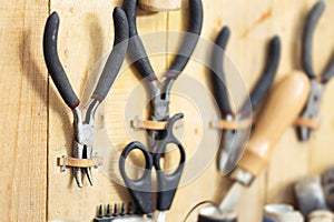 Tools and leather at cobbler workplace. Set of leather craft tools on wooden background