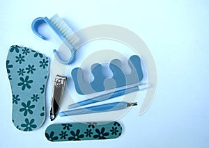 Tools of a manicure and pedicure set on blue background