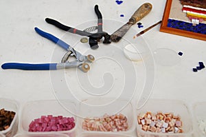 Tools for occupation of a color glass mosaic: brushes, glue, cutters. Creativity and learning.