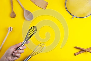 Tools pastry kitchen utensile for cooking dessert, over yellow background with copy space, still life. Top view.