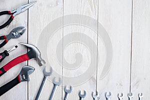Tools for repair on white wooden background. Space for the test photo