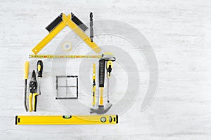 Tools Shape of House, Home Improve and Repair Concept. Wooden Background