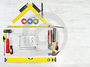 Tools shape of house, Home improving, repair concept. Wooden background photo