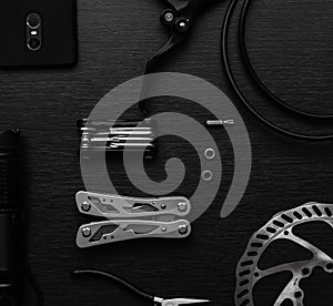 Tools on the table. flat lay. brake disc, multitool, pliers, flashlight