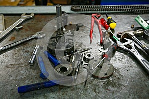 Tools on table in workshop or the garage for repair the machine with spare part of the machine. Technician work on the workshop