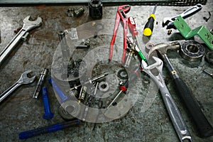 Tools on table in workshop or the garage for repair the machine with spare part of the machine. Technician work on the workshop