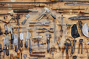 The tools of a tanner on the wall in a tannery.