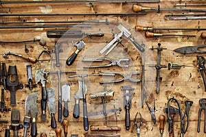 The tools of a tanner for working with leather on the wall in a tannery.