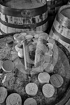 Tools to insert and remove bungs from whisky barrels, on the top  of a dusty old whisky barrel