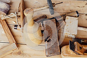 Tools to work with the carpenter`s wood on the table as a background