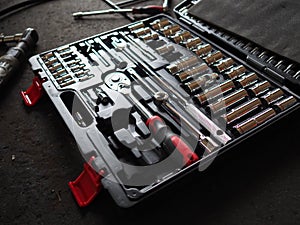 Tools in toolbox lying on the floor. Low key toned image