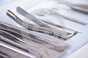 The tools of the trade. Closeup view of dental surgical instruments lying in a row.