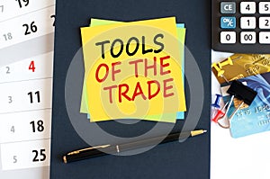 tools of the trade - text on yellow paper on blue background, concept