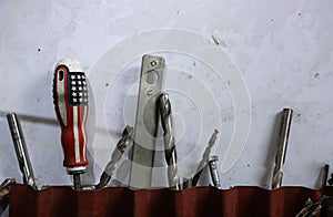 Tools in the workshop drills, screwdrivers, scissors on the metal