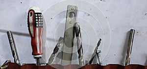 Tools in the workshop drills, screwdrivers, scissors on the metal