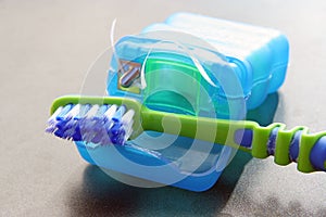 Tooth brush and floss. Used toothbrush and floss.