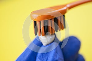 Tooth brush and milk teeth on yellow background