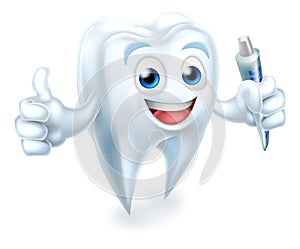 Tooth Dental Mascot Holding Toothpaste photo