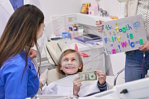 Tooth fairy rewarding little girl