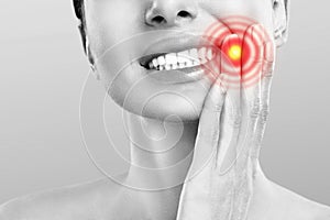 Tooth Pain And Dentistry. Young Woman Suffering From Strong Teeth Pain, Touching Cheek With Hand. Female Feeling Painful