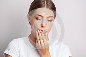 Tooth problems, an attractive woman is experiencing a painful toothache.