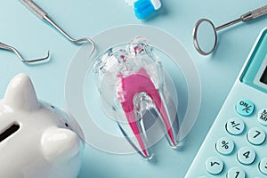 Tooth and tools with piggy bank and calculator on blue background