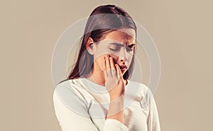 Toothache beautiful woman touches her face with her hand